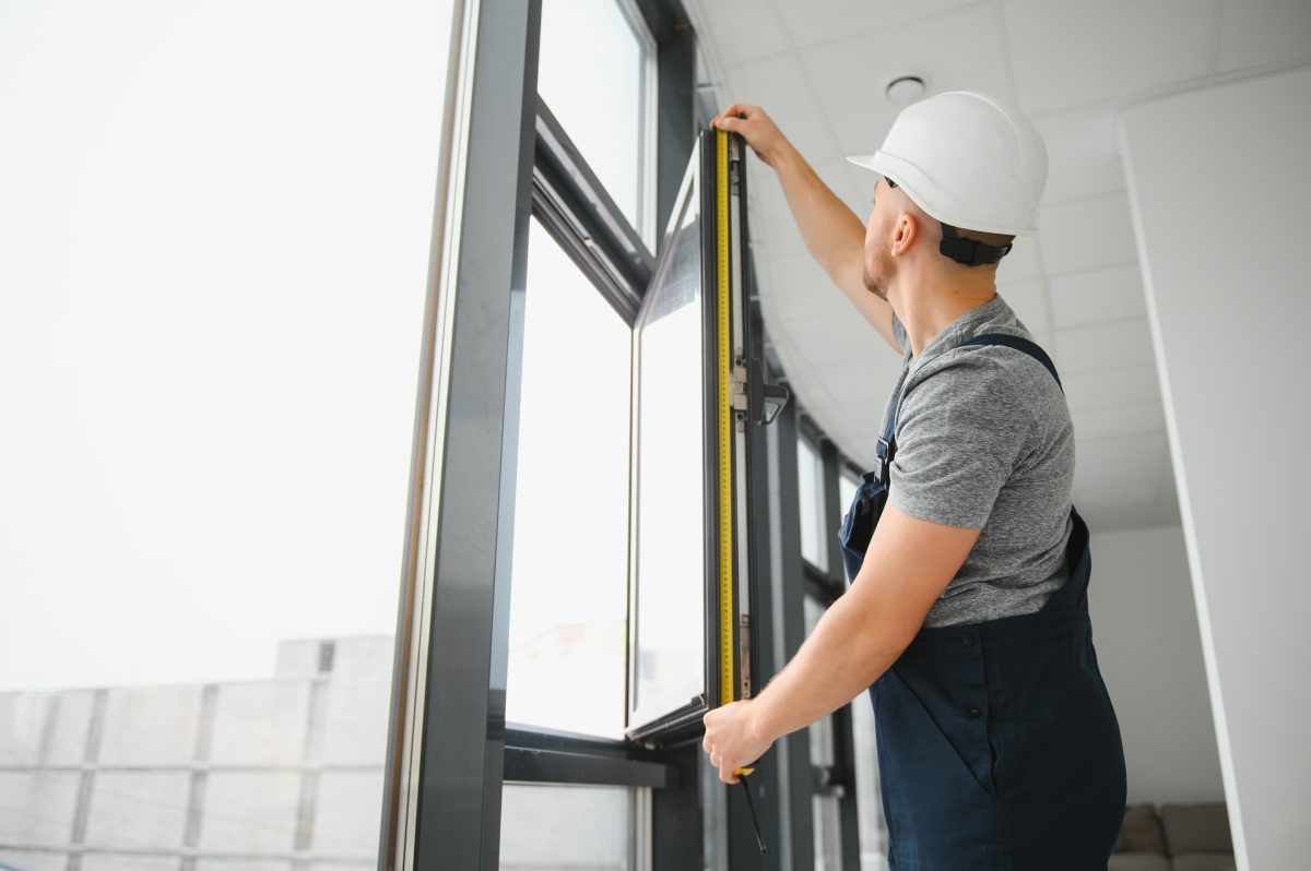 construction-worker-repairing-plastic-window-with-screwdriver-indoors-space-text-banner-design-5-scaled-1.jpg